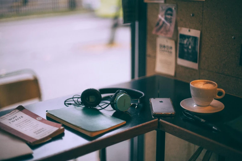 a table with a cup of coffee and headphones on it, trending on unsplash, happening, dusty library, background image, lo-fi art, high quality image”