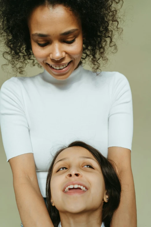 a woman standing next to a little girl, by Nina Hamnett, trending on unsplash, renaissance, showing teeth, laying on their back, plain background, vocal tract model
