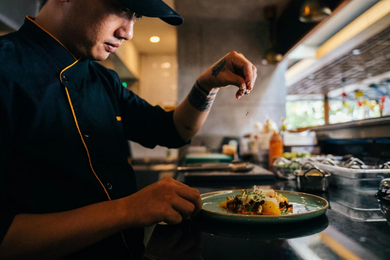 a man in a kitchen preparing food on a plate, darren quach, profile image, lachlan bailey, avatar image