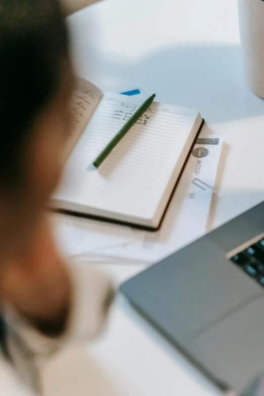 a laptop computer sitting on top of a desk next to a cup of coffee, trending on pexels, pencil and paper, looking across the shoulder, an open book, thumbnail