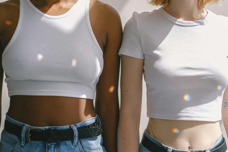 a couple of women standing next to each other, trending on pexels, happening, wearing a cropped tops, pearlescent white, anatomically accurate, varying ethnicities