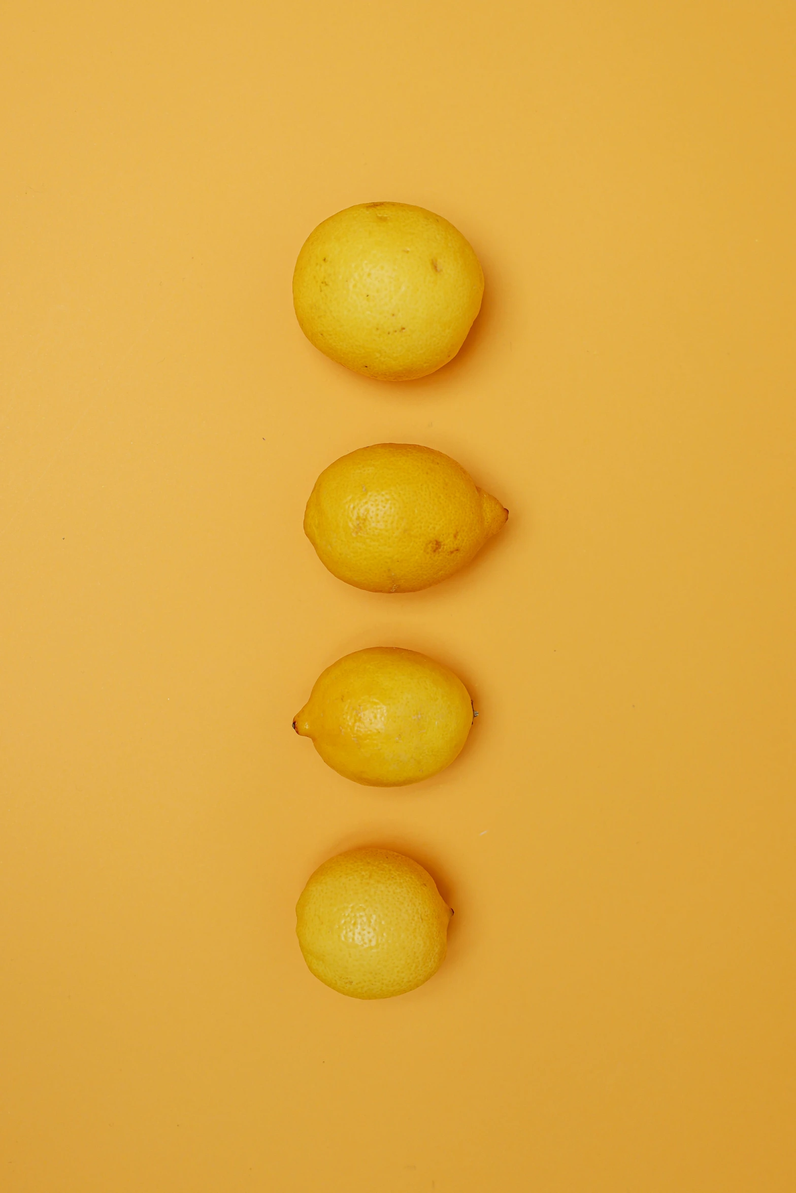 a group of lemons sitting on top of a yellow surface, 4l, upper body image, f/1.4, potato