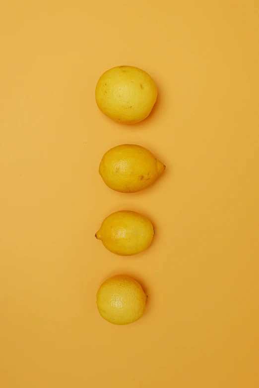 a group of lemons sitting on top of a yellow surface, 4l, upper body image, f/1.4, potato