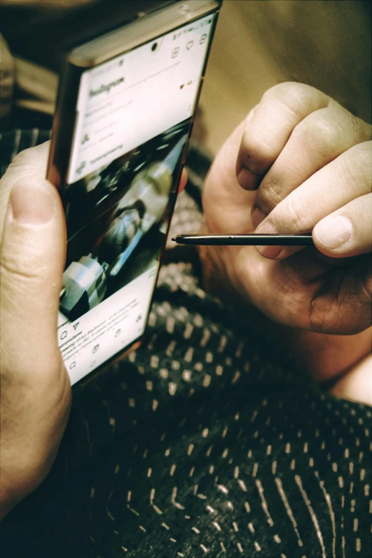 a close up of a person holding a cell phone, a picture, pexels contest winner, hyperrealism, holding pencil, gaming, facebook post, high angle shot