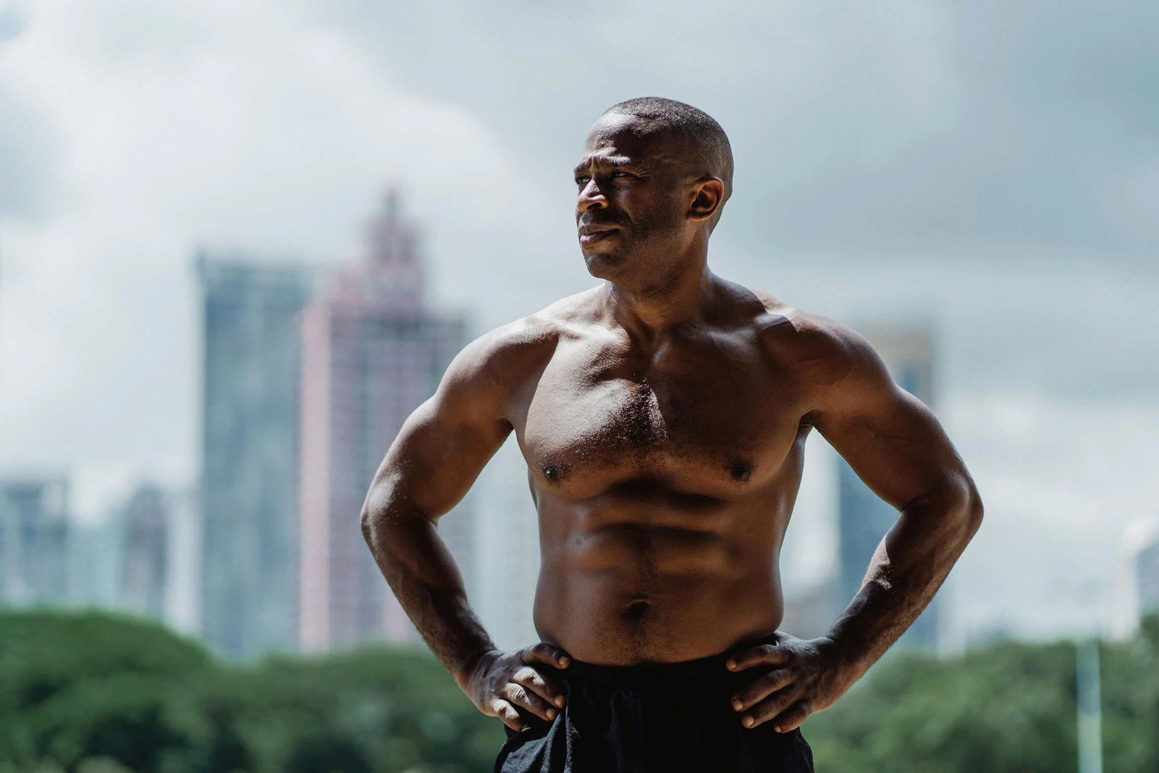 a man standing with his hands on his hips, pexels contest winner, figuration libre, sweaty abs, george floyd, mid - 3 0 s aged, with a city in the background