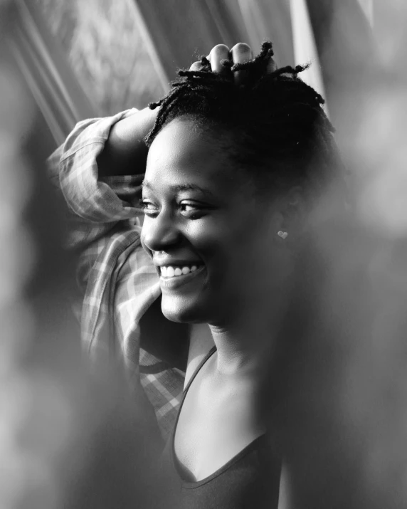 a black and white photo of a woman getting her hair done, pexels contest winner, lupita nyong'o, smiling :: attractive, promo image, dreamy mood