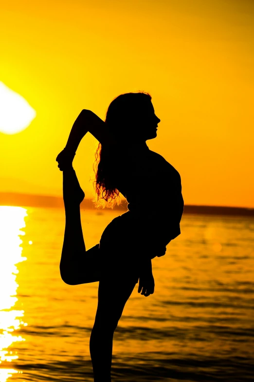 a woman doing yoga on the beach at sunset, a picture, by Sven Erixson, arabesque, doing a sassy pose, no cropping, ((sunset)), medium close shot