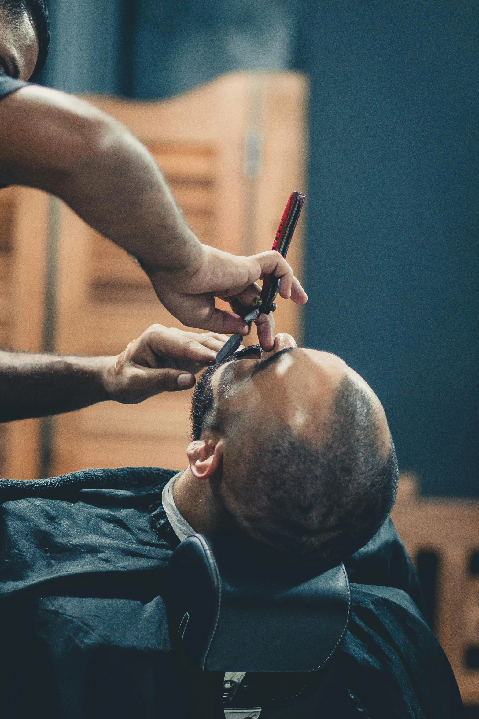 a man getting his hair cut at a barber shop, trending on pexels, shaved bald head, thumbnail, square masculine jaw, ilustration