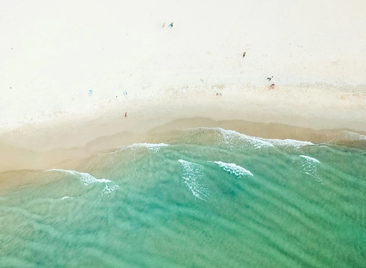 a group of people standing on top of a sandy beach, by Carey Morris, pexels contest winner, minimalism, aerial iridecent veins, green and white, gold coast australia, crystal clear water