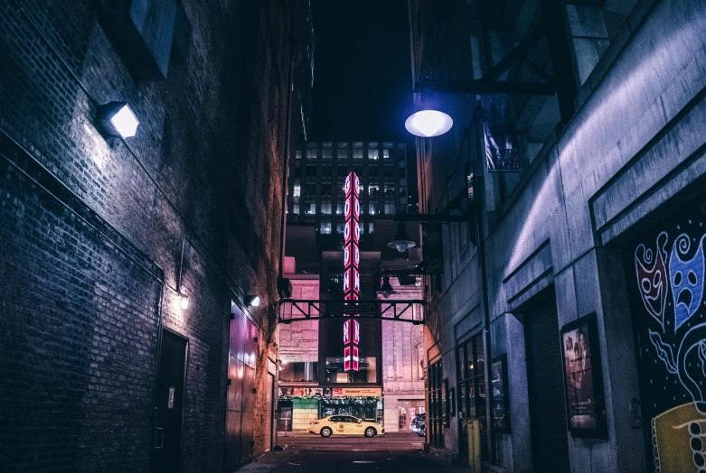 a city street at night with a neon sign, a photo, pexels contest winner, location [ chicago ( alley ) ], lampposts, an old cinema, instagram photo