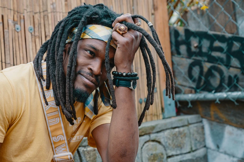 a man with dreadlocks posing for a picture, inspired by Ras Akyem, trending on pexels, afrofuturism, center of image, thumbnail, jamaican