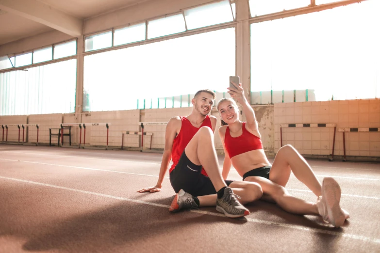 a couple of women sitting on top of a tennis court, pexels contest winner, athletic crossfit build, avatar image, taking selfies, wearing red shorts