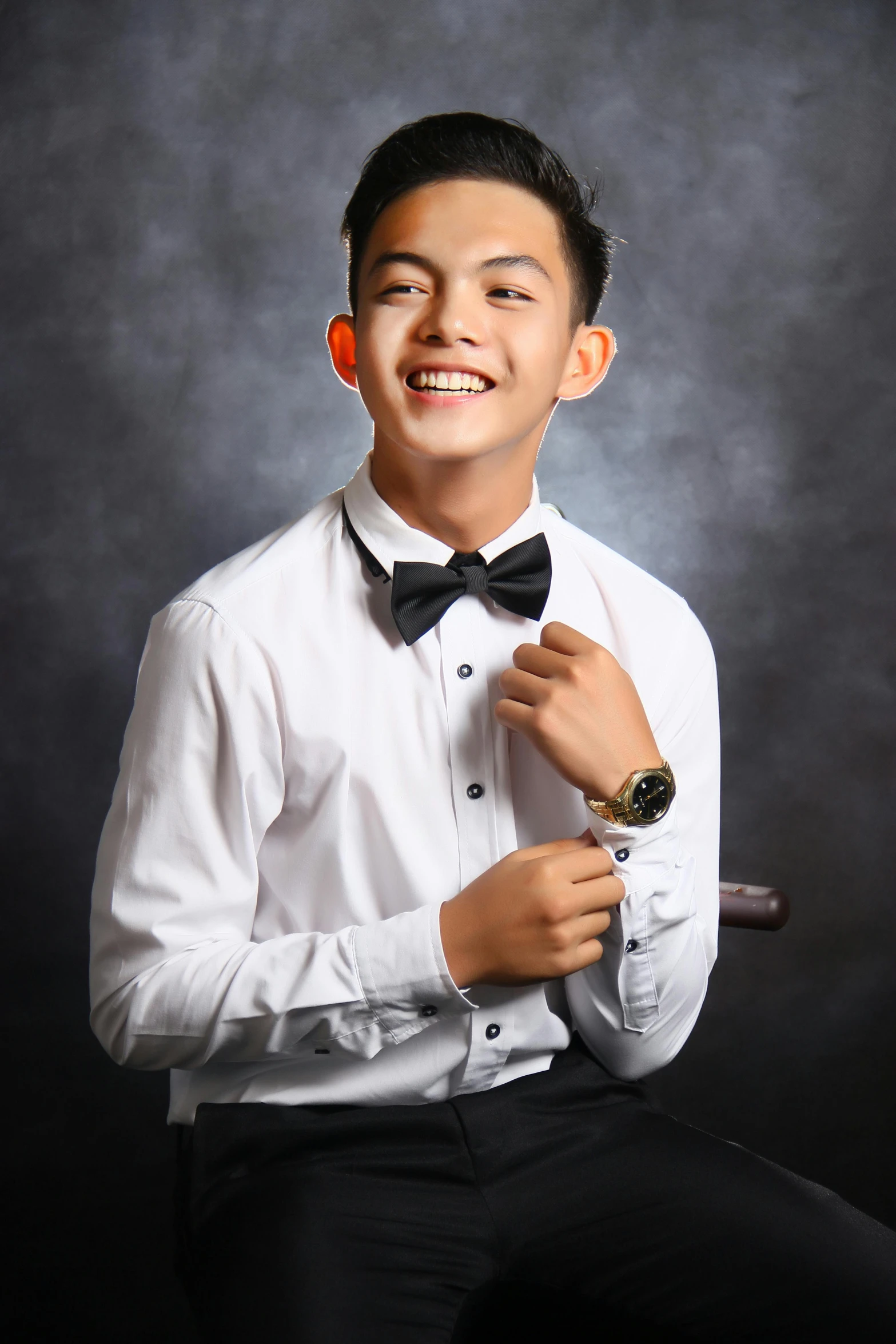 a man in a white shirt and black bow tie, an album cover, inspired by Ryan Yee, pexels contest winner, portrait of 1 5 - year - old boy, barong family member, 15081959 21121991 01012000 4k, award winning studio photo