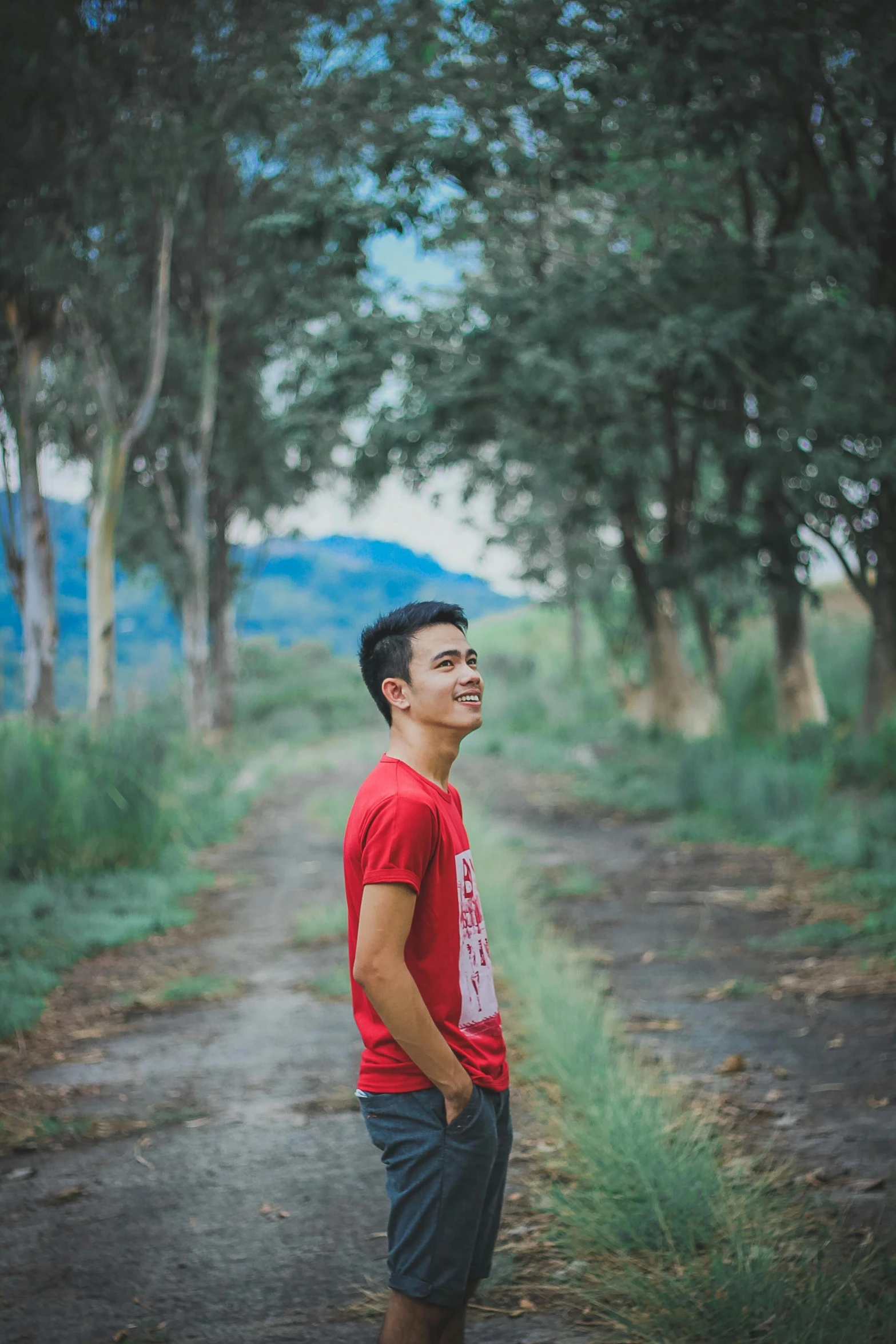 a man standing in the middle of a dirt road, handsome chad chin, avatar image, coloured photo, male teenager