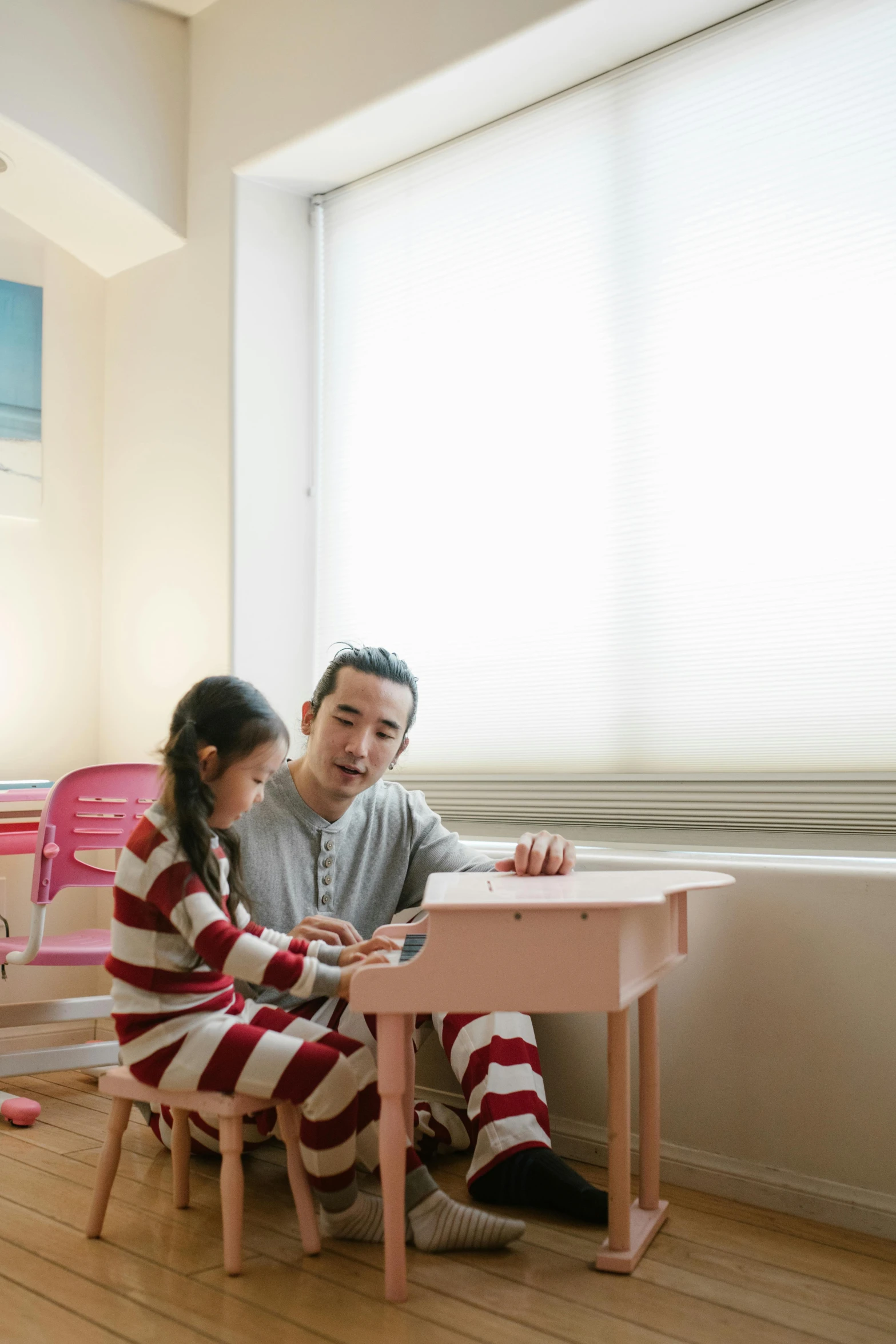 a man and a little girl sitting at a table, pexels contest winner, shin hanga, candy hospital room, classroom, wearing pajamas, future coder