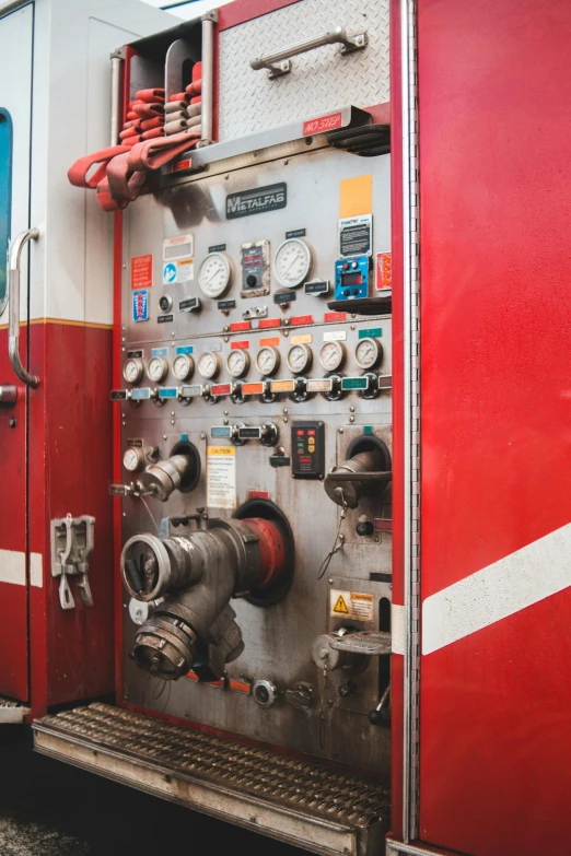 a red and white fire truck parked next to a building, unsplash, control panel, square, valves, analog photo