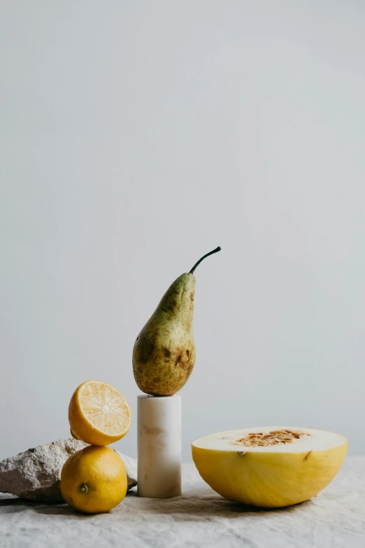 a bunch of fruit sitting on top of a table, a still life, trending on pexels, made of carrara marble, lemonlight, grain”, pear