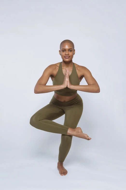 a woman doing yoga poses on a white background, by Nina Hamnett, olive green, in spandex suit, african american, promo image