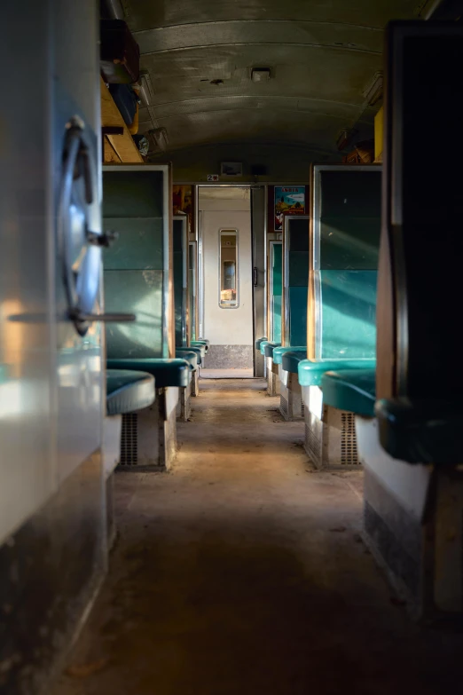 a long hallway with benches and a door, by Tobias Stimmer, unsplash, inside an underwater train, choo choo, evening sunlight, portholes