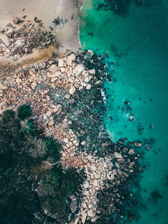 an aerial view of a beach and a body of water, by Adam Marczyński, rocky environment, australian beach, stunning screensaver, less detailing