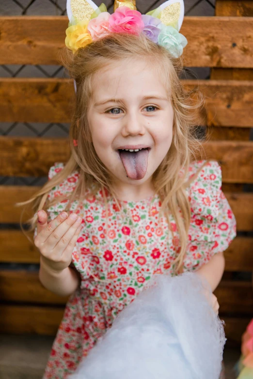 a little girl sticking out her tongue in front of a cake, a picture, shutterstock contest winner, cotton candy, model posing, full frame image, filthy
