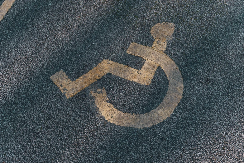 a handicap sign painted on the asphalt of a parking lot, an album cover, unsplash, auto-destructive art, square, brown, wheelchair, highly technical