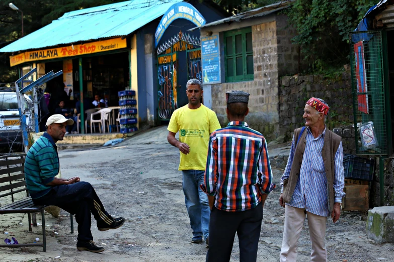 a group of men standing next to each other on a dirt road, pexels contest winner, happening, stood outside a corner shop, uttarakhand, ethiopian, flirting