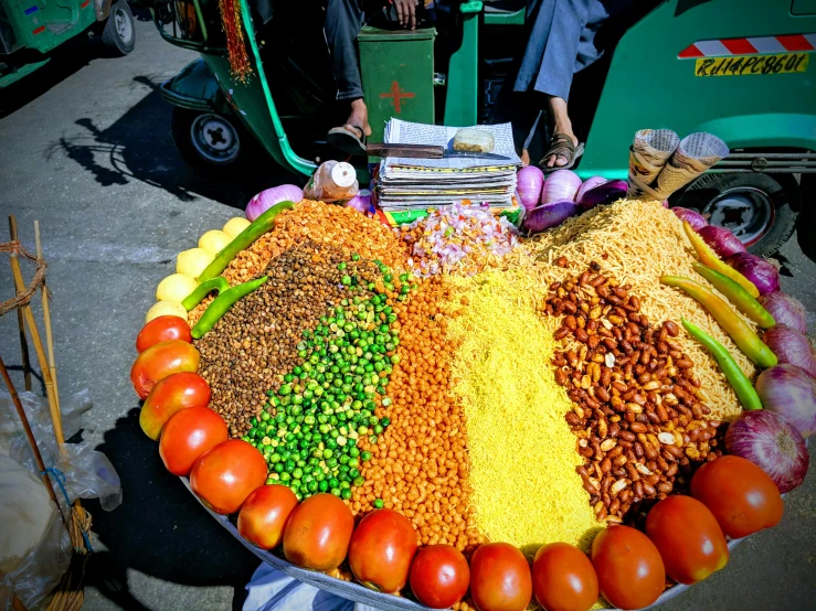 a table topped with lots of different types of food, an album cover, by Julia Pishtar, trending on unsplash, on an indian street, chile, corn, cart