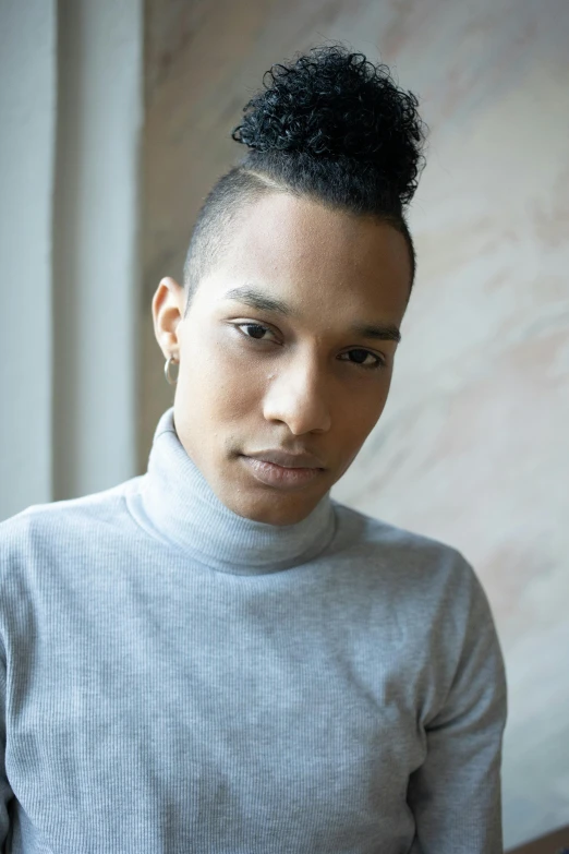 a close up of a person wearing a sweater, by William Berra, androgynous male, jemal shabazz, looking to camera, thin young male