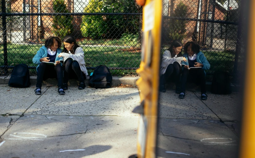 a couple of girls sitting next to each other on a sidewalk, ashcan school, trying to read, ignant, marking lines, jemal shabazz