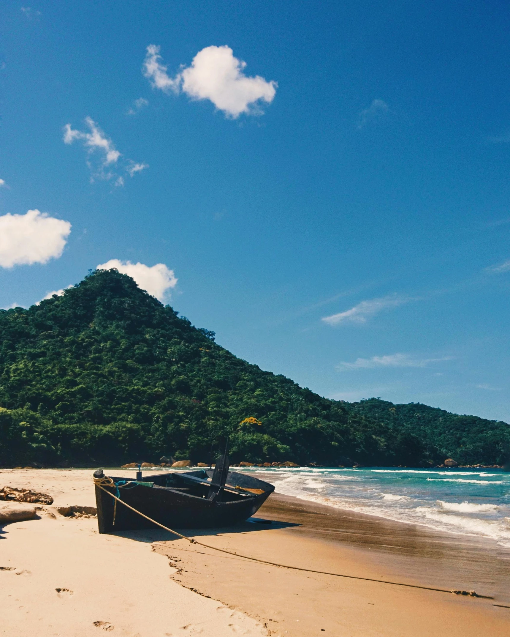 a boat sitting on top of a sandy beach, mountainous jungle setting, profile image