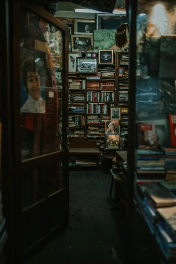 a book store filled with lots of books, a picture, by Elsa Bleda, pexels contest winner, about to enter doorframe, gif, looking towards camera, antiques