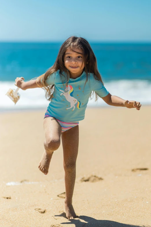 a little girl is running on the beach, a portrait, by Greg Spalenka, shutterstock contest winner, tan skin a tee shirt and shorts, mermaids, sri lanka, professionally color graded