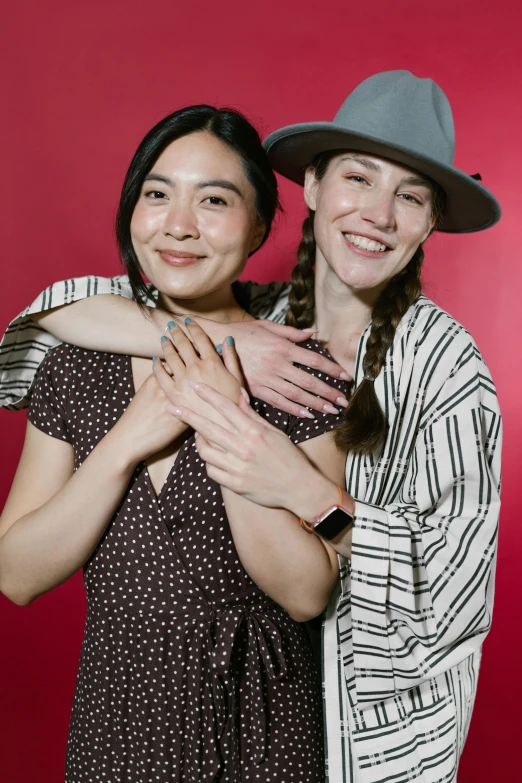 a couple of women standing next to each other, promo image, greg rutkowski ruan jia, red hat, bisexual lighting