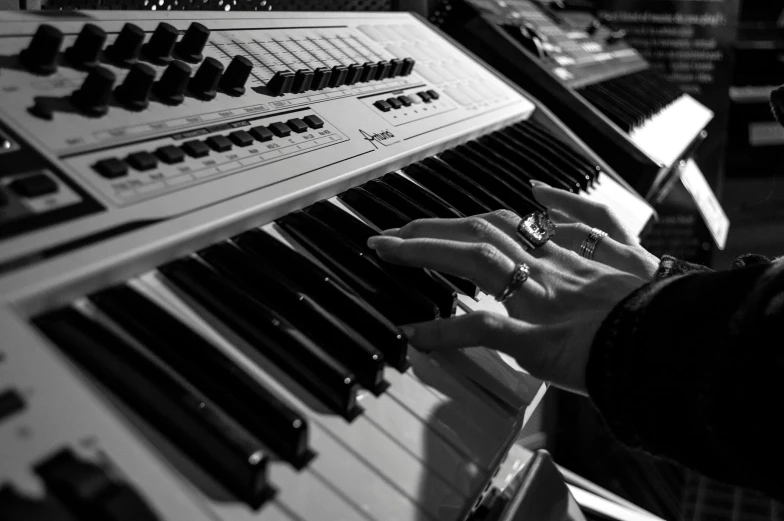 a close up of a person playing a musical instrument, synthetism, greyscale, synthesizers, profile picture, marketing photo