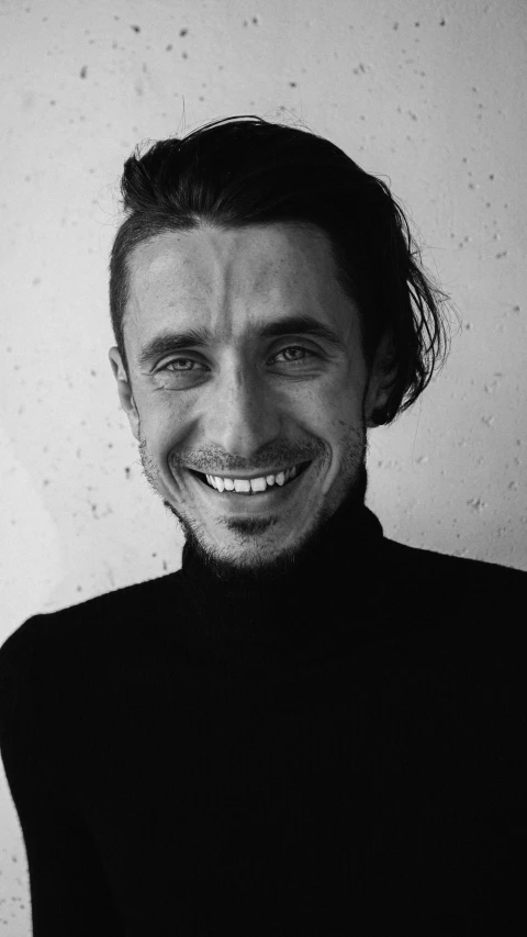 a black and white photo of a man smiling, inspired by Tommaso Redi, jacques - yves cousteau, hedi slimane, wearing turtleneck, 15081959 21121991 01012000 4k