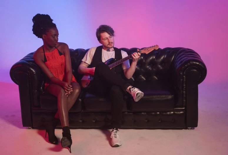 a couple of people that are sitting on a couch, an album cover, by Arabella Rankin, performing a music video, youtube thumbnail, taken with sony alpha 9, lupita nyong'o