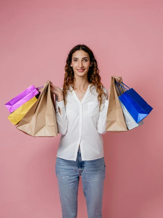 a woman holding shopping bags on a pink background, by Julia Pishtar, pexels contest winner, renaissance, 15081959 21121991 01012000 4k, brown, plain background, promotional image