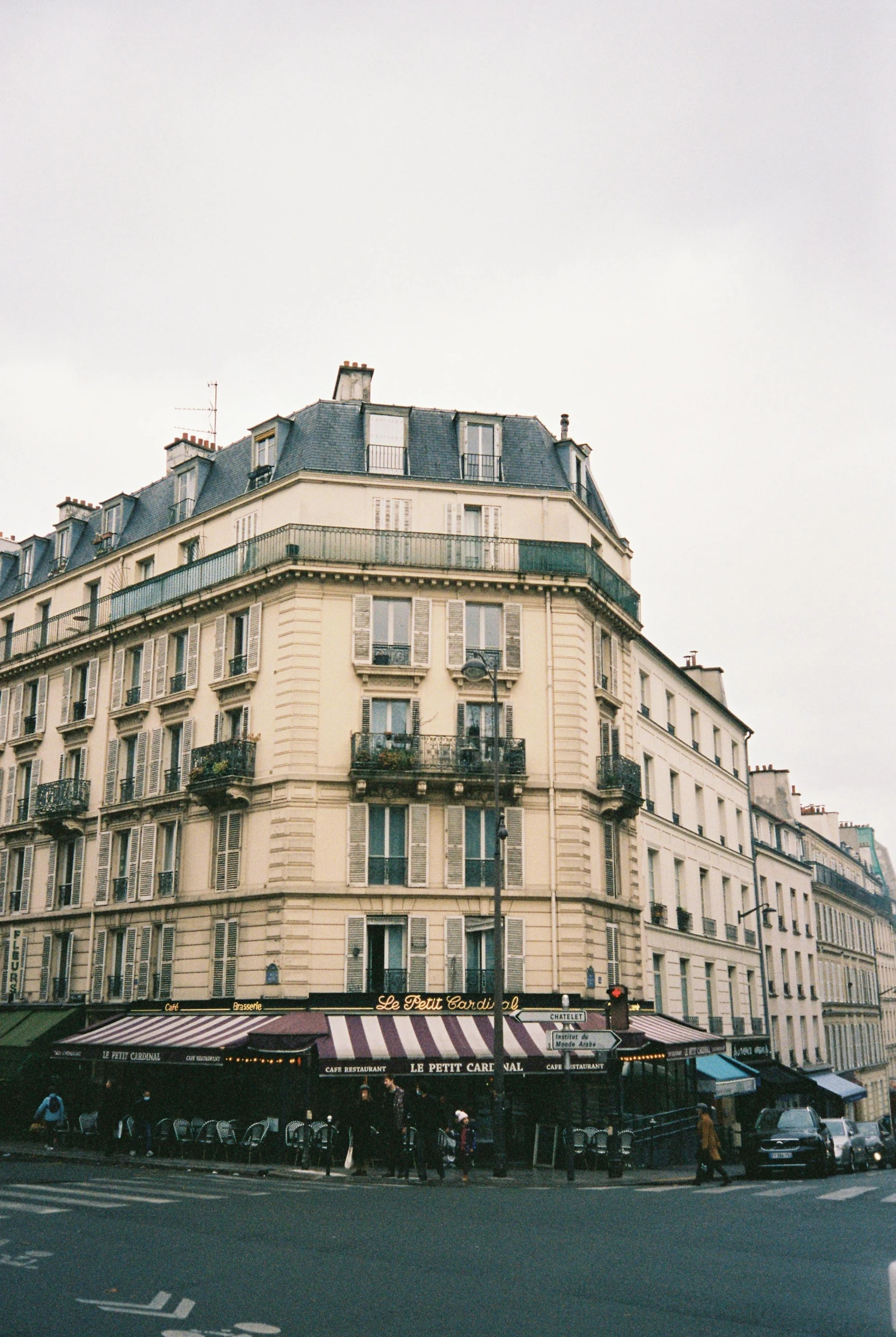 a very tall building sitting on the side of a street, a photo, unsplash, paris school, nice slight overcast weather, house's and shops and buildings, film photo, square