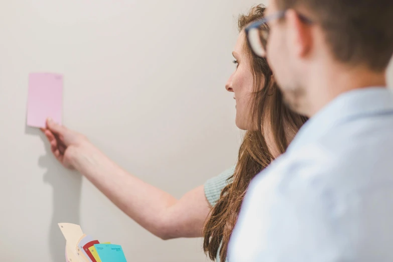 a man and a woman standing next to each other, a photo, whiteboards, background image, profile image, conor walton