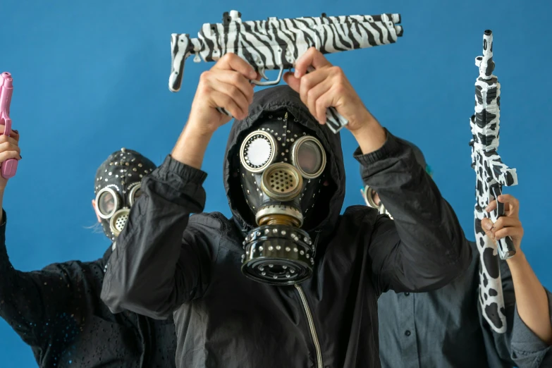 a person wearing a gas mask holding a pair of scissors, by Nina Hamnett, pexels contest winner, ferrofluid armor, holding a blaster, two figures wearing gas masks, stylish coat for a rave