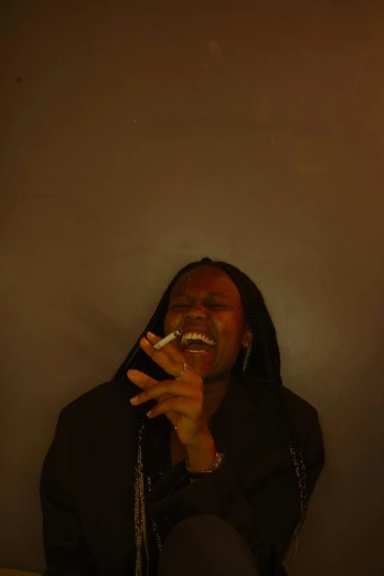 a woman sitting on a bed smoking a cigarette, an album cover, by Terrell James, unsplash, brown skin man with a giant grin, chris cunningham, standing in a dimly lit room, ((portrait))