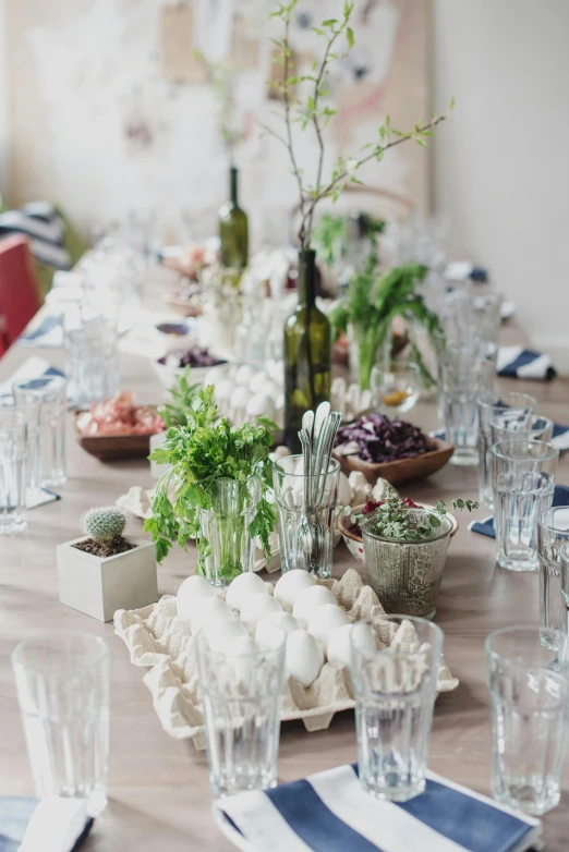 a table that has a bunch of place settings on it, by Jessie Algie, unsplash, renaissance, plants in glasses, long shot from back, wine, lots of jars and boxes of herbs