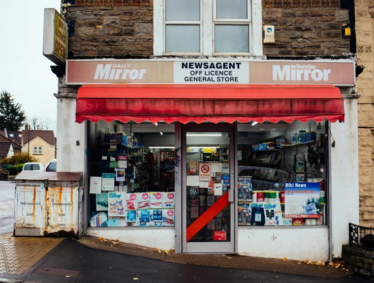 a building with a red awning in front of it, by Nick Fudge, pexels contest winner, hyperrealism, convenience store, mirrors, magazine photo, panoramic