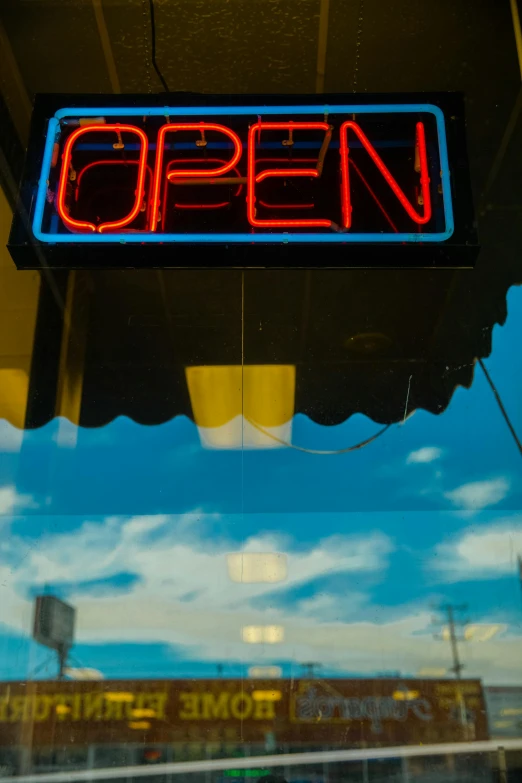 an open sign hanging from the side of a building, by Matt Cavotta, unsplash, android coffee shop, thumbnail, multiple stories, vibrant backlit