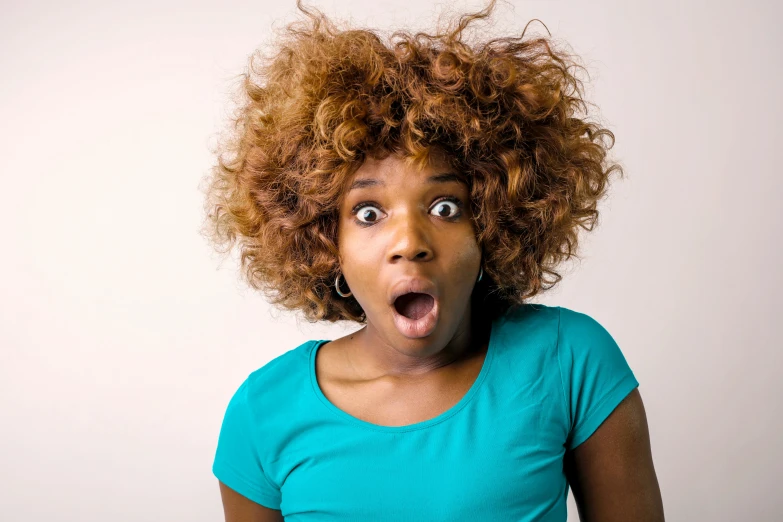 a woman with a surprised look on her face, pexels, happening, natural hair, thumbnail, all overly excited, coloured