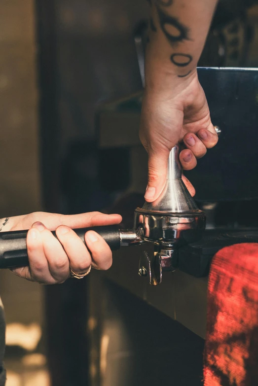 a close up of a person using a coffee grinder, an engraving, trending on unsplash, aussie baristas, thumbnail, piping, plating