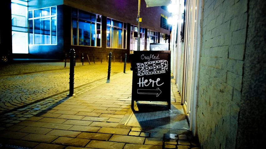 a sign that is on the side of a building, by Nick Fudge, unsplash, on a street at night, square, chesterfield, i'm here