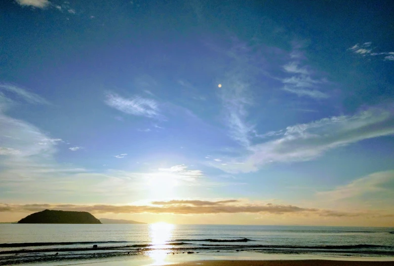 a large body of water sitting on top of a sandy beach, a picture, with two suns in the sky, marsden, beach, big sky