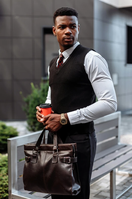 a man sitting on a bench holding a cup of coffee, inspired by Terrell James, suit vest, holding a leather purse, avant designer uniform, standing confidently